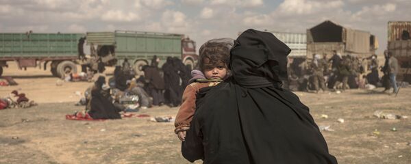 Женщина несет своего ребенка  - Sputnik Тоҷикистон