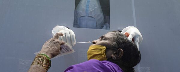 Женщина в мобильном пункте сдачи теста на коронавирус в Хайдарабаде, Индия  - Sputnik Тоҷикистон