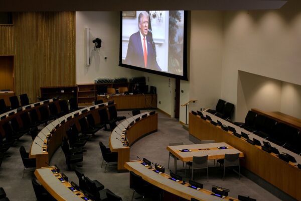 Огромный экран в пустом зале ООН транслирует выступление лидеров разных стран. На фото - выступление президента США Дональда Трампа - Sputnik Таджикистан