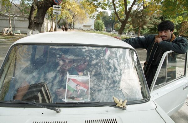 Предвыборный плакат Эмомали Рахмонова за стеклом автомобиля, 1994 год - Sputnik Таджикистан