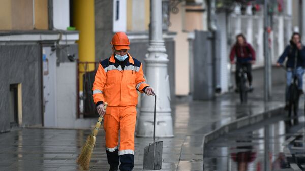 Сотрудник коммунальной службы убирает улицу в Москве, архивное фото - Sputnik Тоҷикистон
