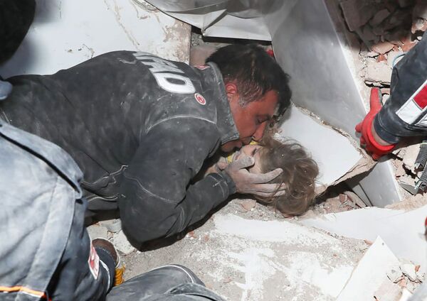 Турецкие спасатели вытаскивают ребенка из под обломков после землетрясения в Измире - Sputnik Тоҷикистон