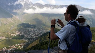 Туристы фотографируют посёлок городского типа Степанцминда