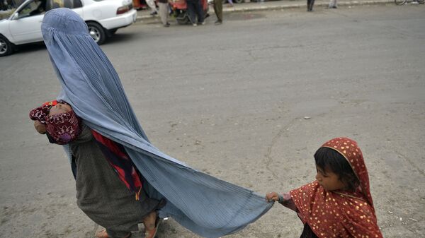 Женщина в бурке с ребенком на улице в Кабуле - Sputnik Тоҷикистон