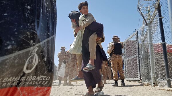 Афганцы во время перехода через пакистано-афганскую границу после прихода к власти Талибов* - Sputnik Тоҷикистон