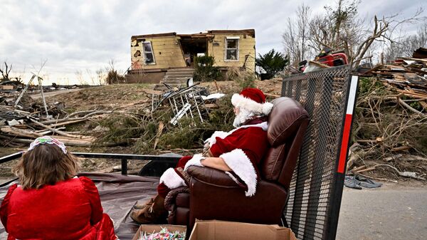 Люди в рождественских костюмах в разрушенном торнадо Доусон-Спрингс, Кентукки, США - Sputnik Таджикистан