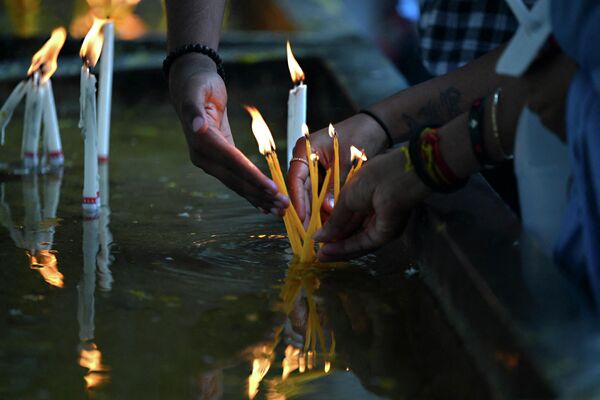Верующие зажигают свечи во время пасхальной воскресной службы в церкви Святого Антония в Коломбо, Шри-Ланка. - Sputnik Таджикистан