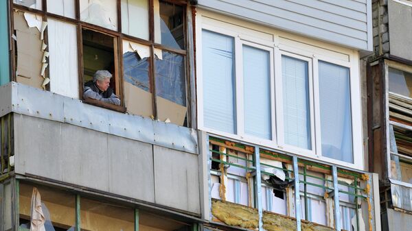 Женщина на балконе жилого дома в городе Рубежное Луганской народной республики - Sputnik Тоҷикистон