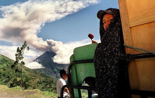 Женщина ест мороженое во время извержения вулкана Тунгурауа, Патате, 1999 год. - Sputnik Таджикистан