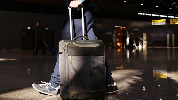 Пассажир с багажом в аэропорту - Sputnik Тоҷикистон