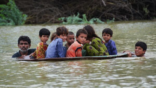 Дети в спутниковой антенне во время наводнения в Пакистане  - Sputnik Таджикистан