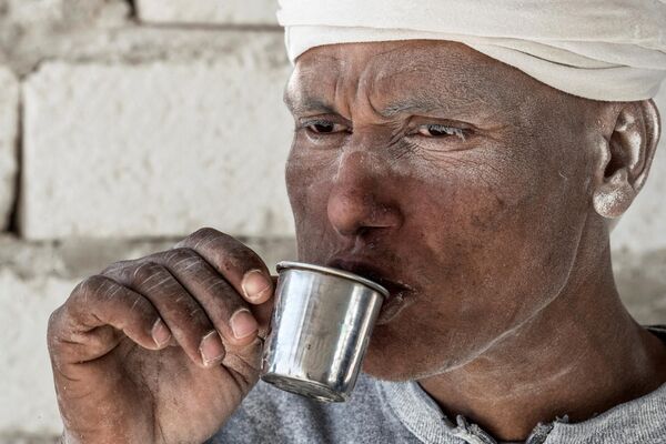 Рабочий пьет чай в карьере по добыче известняка &quot;Белая гора&quot; недалеко от южного египетского города Минья. - Sputnik Таджикистан
