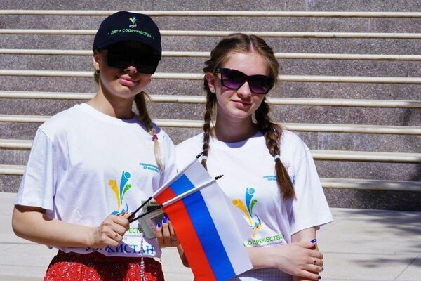 Российские школьницы с флагами. - Sputnik Таджикистан