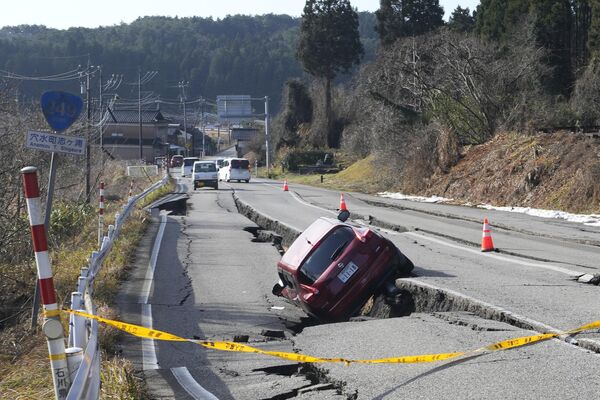 Автомобиль застрял на частично разрушенной дороге, вызванной мощным землетрясением 2 января. - Sputnik Таджикистан