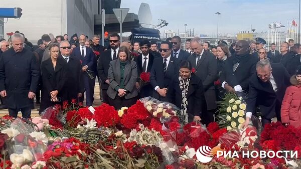 Главы и сотрудники зарубежных дипмиссий у мемориала в память о жертвах теракта в Крокусе - Sputnik Таджикистан