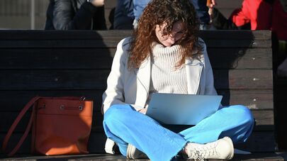 Девушка с ноутбуком на лавочке