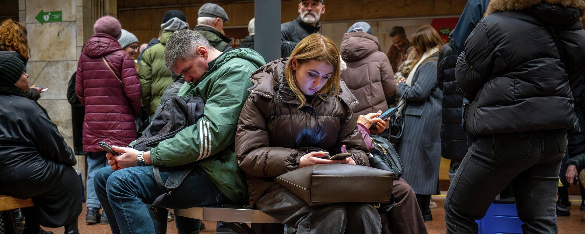 Люди укрываются в бомбоубежище на станции метро в Киеве, Украина, во вторник, 23 декабря 2025 года. - Sputnik Таджикистан, 1920, 19.01.2026