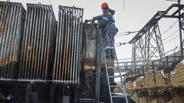 Рабочий ремонтирует подстанцию, поврежденную в результате ракетного удара, Харьков, Украина, 20 февраля 2026 года.  - Sputnik Тоҷикистон