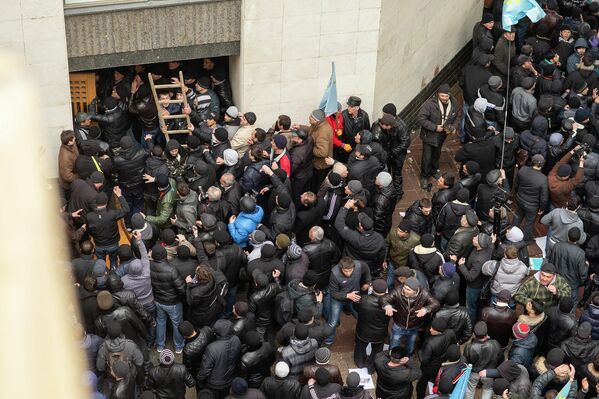 Иштирокчиёни гирдиҳамоии оммавии "Барои дифоъ аз Қрим шӯриш кунед" дар наздикии бинои Радаи Олии Қрим дар Симферопол. - Sputnik Тоҷикистон