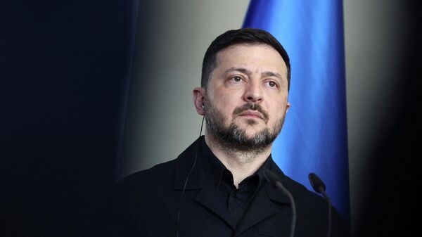 Владимир Зеленский во время визита в Берлин, Германия, 14 апреля 2026 года. - Sputnik Тоҷикистон