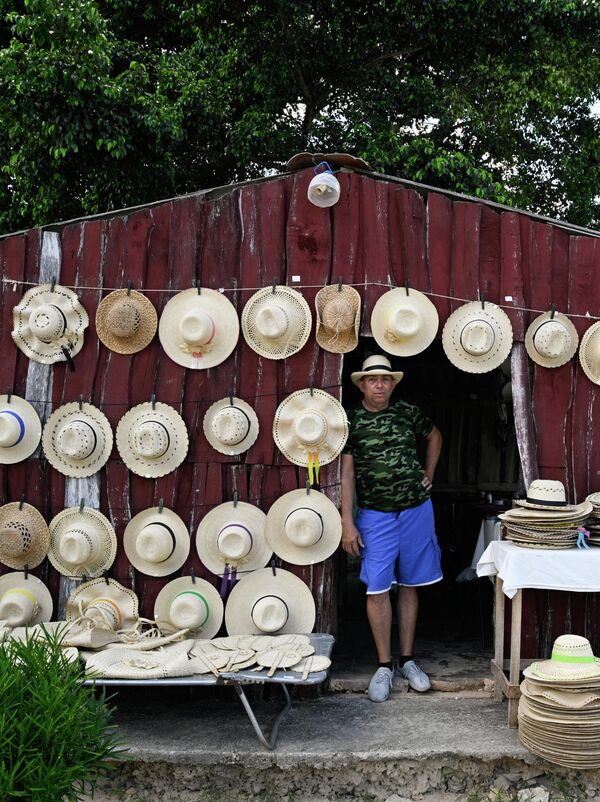 Фурӯшандае, ки дар дӯконе дар Плая Ларга сомбреро пӯшидааст. - Sputnik Тоҷикистон