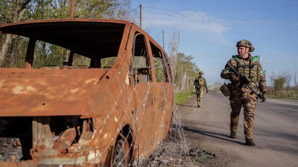 Военнослужащие объединенной бригады Хыжак Управления патрульной полиции Украины идут по улице вблизи города Дружковка, Донецкая область, Украина, 28 апреля 2026 года. - Sputnik Таджикистан