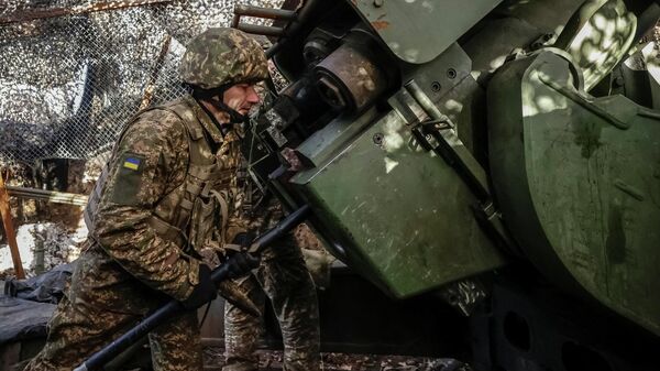 Военнослужащий 13-й оперативной бригады Национальной гвардии Украины заряжает боеприпасы в самоходную гаубицу Богдана, Харьковская область. - Sputnik Тоҷикистон