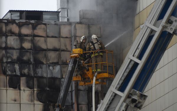 Сотрудники пожарной охраны МЧС во время тушения пожара в торговом центре Зимняя вишня в Кемерове - Sputnik Таджикистан