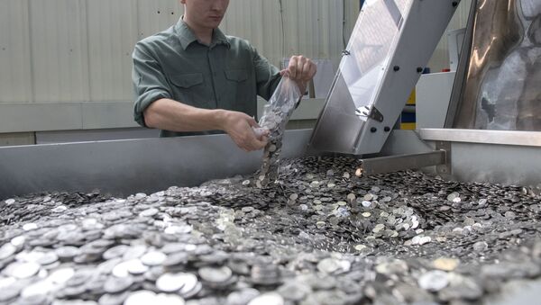 Рабочий на линии упаковки на монетном дворе, архивное фото - Sputnik Таджикистан