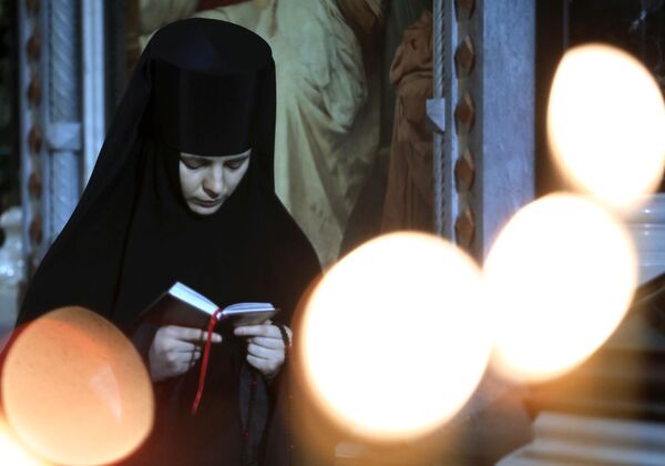 Монахиня перед Рождественским богослужением в храме Христа Спасителя в Москве Монахиня перед Рождественским богослужением в храме Христа Спасителя в Москве - Sputnik Таджикистан