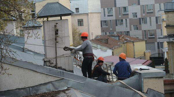 Рабочие-строители на крыше здания в Москве. - Sputnik Таджикистан