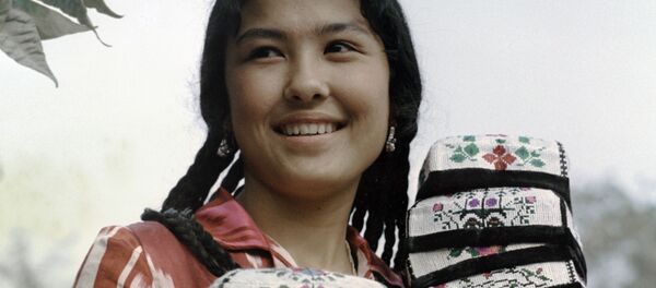 Девушка-таджичка несет стопку вышитых тюбетеек - Sputnik Таджикистан