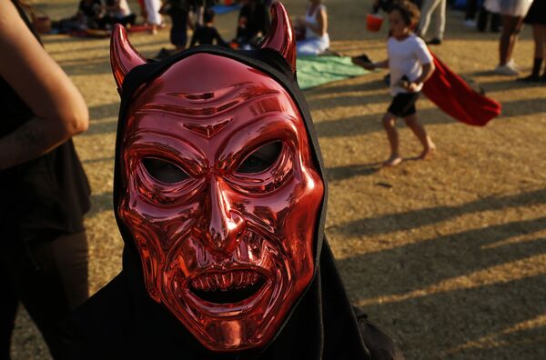 Мужчина в маске во время празднования Хэллоуина в парке Йоханнесбурга, ЮАР - Sputnik Таджикистан