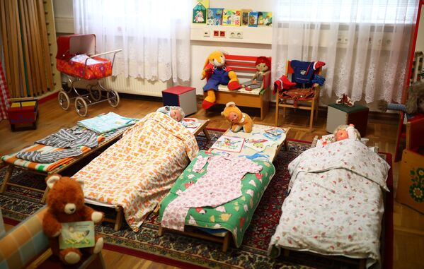 Экспозиция, имитирующая спальню детского сада с игрушками, детской одеждой и книгами. Музей ГДР в Пирне, Германия - Sputnik Таджикистан