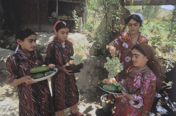 Таджикские девушки в национальной одежде с овощами и фруктами. Предгорье Тянь-Шаня - Sputnik Таджикистан