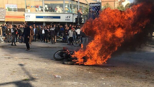 Горящий мотоцикл во время протестов в Иране  - Sputnik Таджикистан