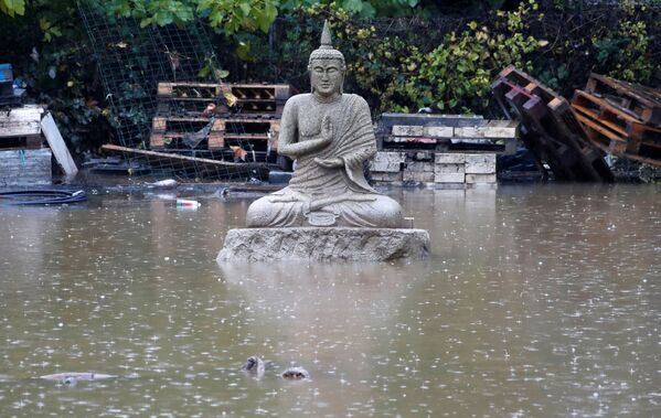 Статуя Будды на одной из улиц Лемю на юго-востоке Франции после наводнения - Sputnik Таджикистан