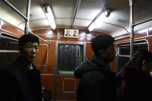 Портреты покойных северокорейских лидеров Ким Ир Сена (слева) и его сына Ким Чен Ира в вагоне столичного метро - Sputnik Таджикистан