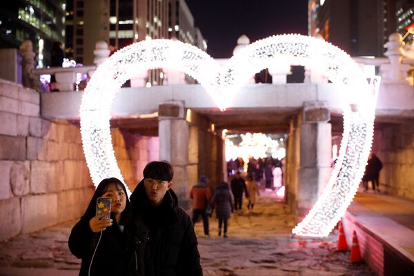 Влюбленная пара во время фотографирования накануне Нового года в Сеуле, Южная Корея  - Sputnik Таджикистан