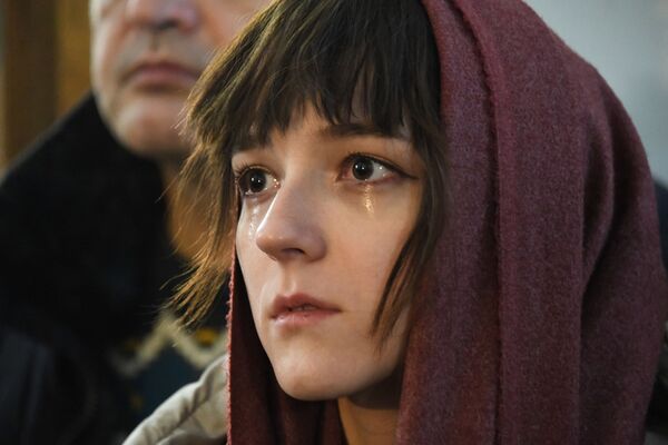 Женщина во время рождественского богослужения в Чите Женщина во время рождественского богослужения в Чите - Sputnik Таджикистан