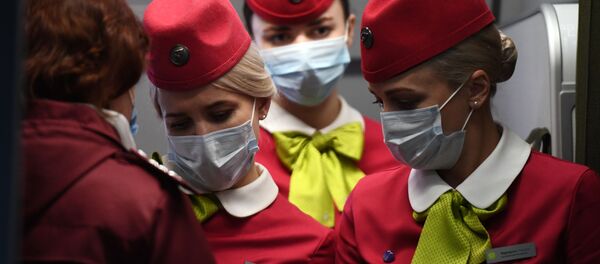 Бортпроводницы рейса авиакомпании S7, прибывшего из Пекина, в аэропорту Толмачево (Новосибирск) - Sputnik Тоҷикистон