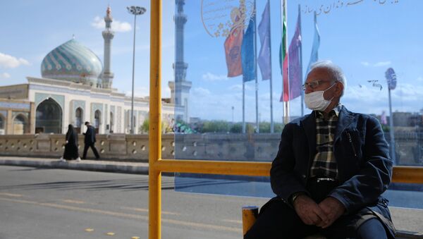 Мужчина на автобусной остановке в Куме, Иран - Sputnik Тоҷикистон