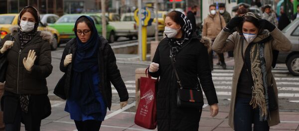 Жители Тегерана идут по одной из центральных улиц в медицинских масках - Sputnik Тоҷикистон